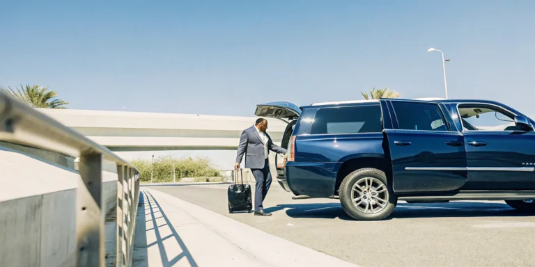 A luxury private vehicle picking up travelers at LAX curbside