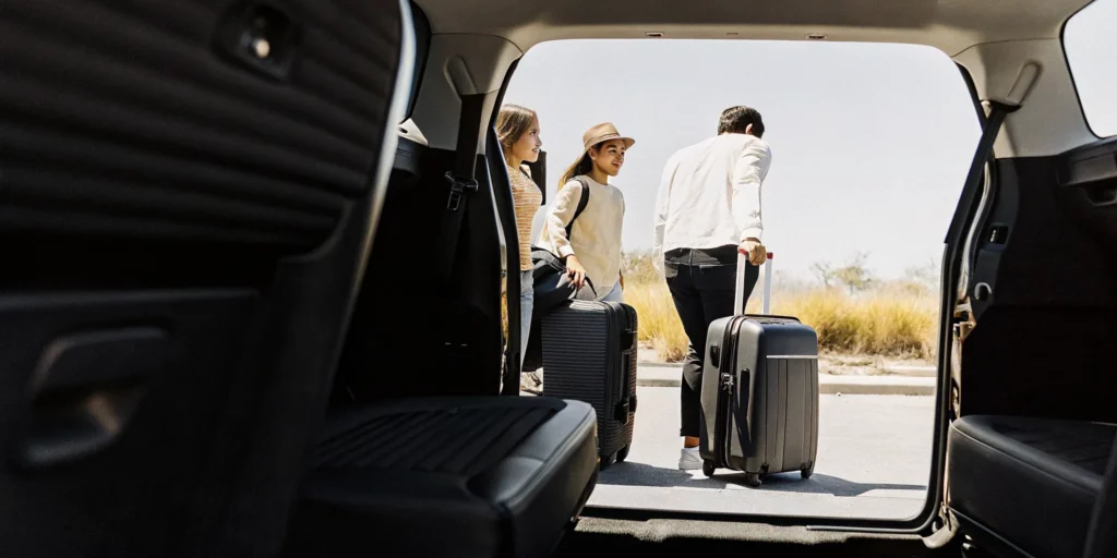 Family with kids boarding a private van shuttle at LAX airport for Disneyland trip