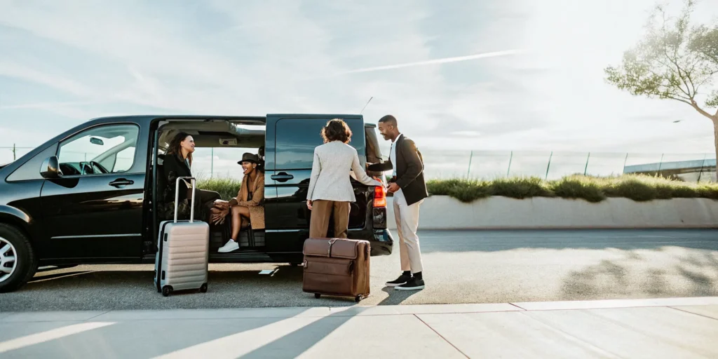 Private group van loading luggage on a Los Angeles airport curb before a trip