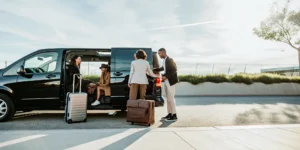 Private group van loading luggage on a Los Angeles airport curb before a trip
