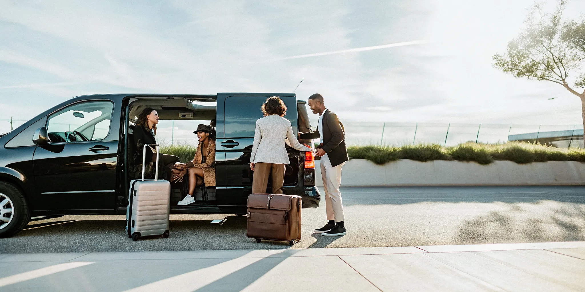 Private group van loading luggage on a Los Angeles airport curb before a trip