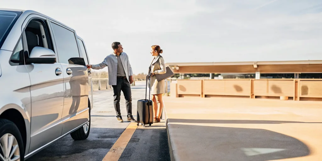 First-time travelers meeting a private van driver for LAX airport pickup