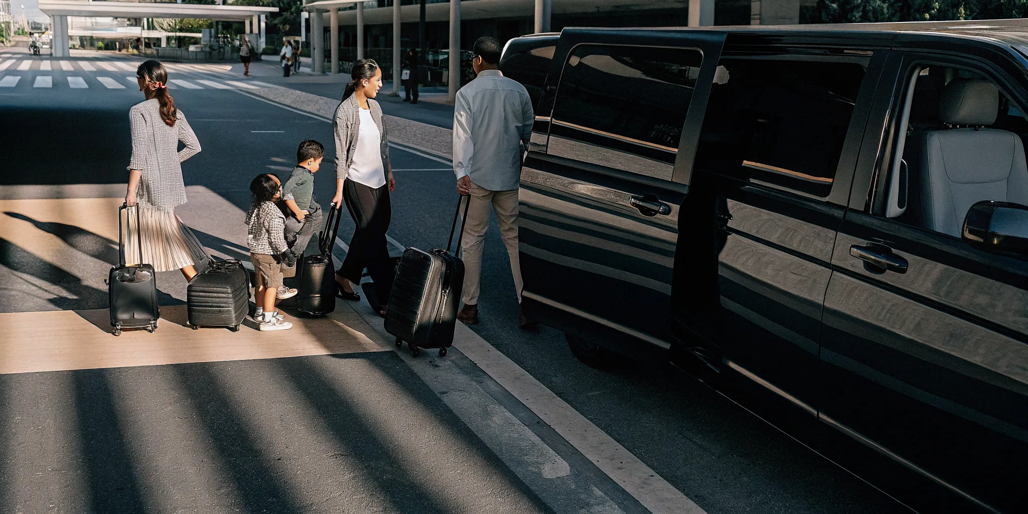 Family group boarding a private airport shuttle near LAX